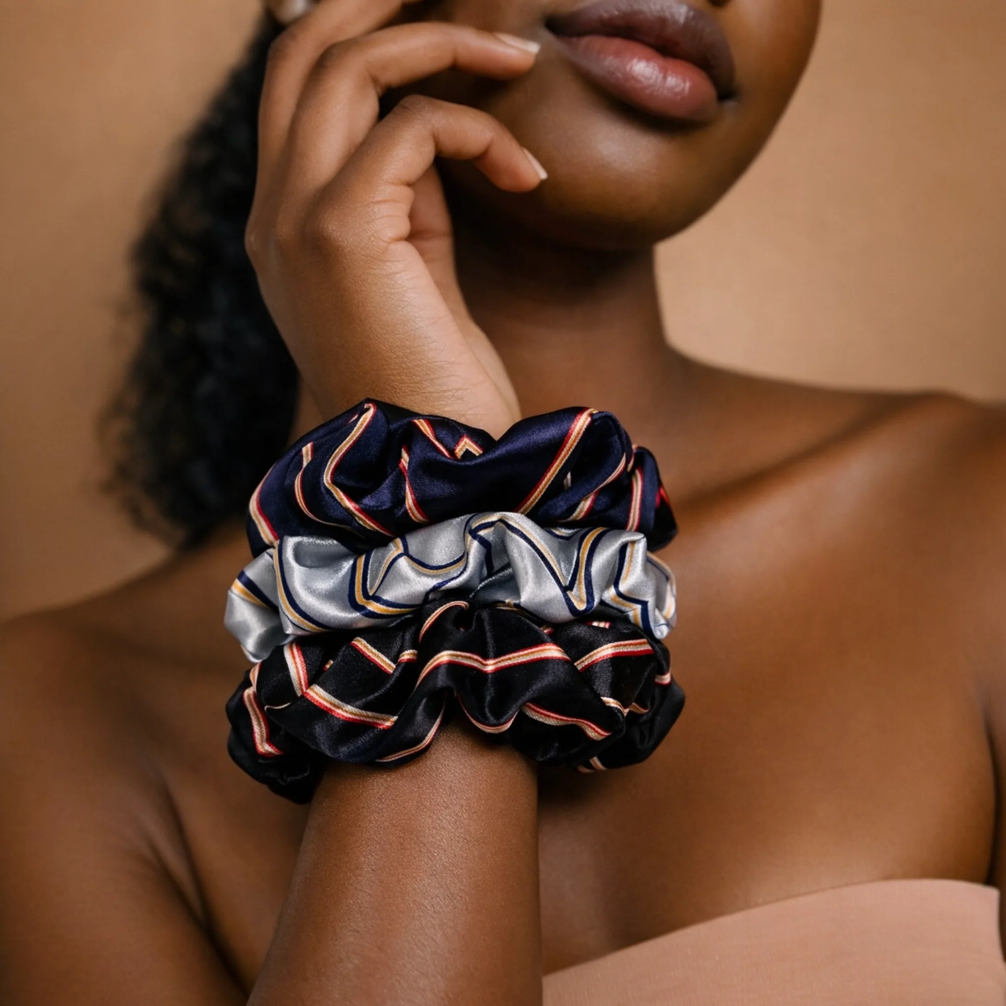 Heritage Hold satin scrunchies in Uptown Navy, Legacy Silver, and Reserve Noir